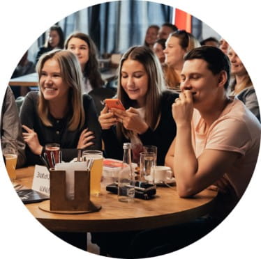 People playing quizzes in a bar